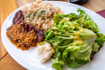 Fried rice with steak beef and vegetables in Japanese style cooking on white dish in restaurant
