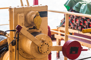 Close-up of the winch and brake mechanism used for operating a lifeboat on a cargo ship — an essential part of the vessel's safety equipment. © Mariusz