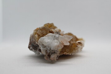 Yellow or brownish Fluorite crystals isolated on a white background. Fluorite from Madagascar. Fluorite on a white background 