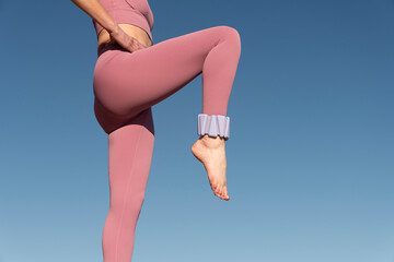 sporty woman with adjustable ankle weights working out