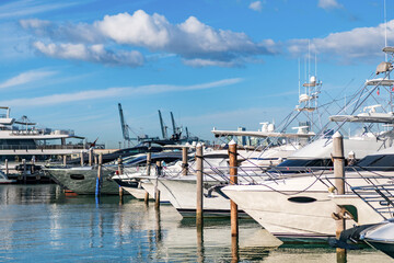 Fototapeta premium Summer vacation. Luxury marina. Motorboat yacht sailing at sea. Yachting boat tourism. Motorboat sea marina. Luxury yacht marina. Docked luxurious yacht boat. Luxury harbor. Motorboat at sea