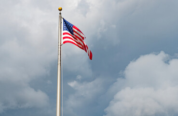 American flag waving for independence day. Flag of the USA. National waving flag of united states on blue sky. Independence day. Patriotic symbol. American Flag for Memorial Day or 4th of July