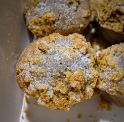 Close up of a muffin with powdered sugar.