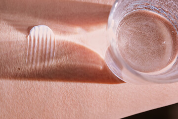 Texture of cosmetic products on skin with water reflection. Moisturizing concept.