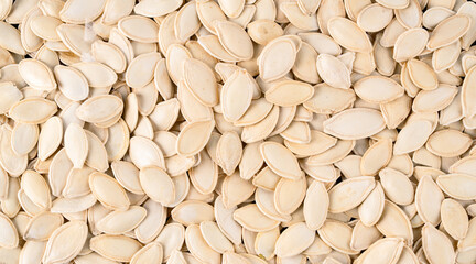 Delicious pumpkin seeds on white background