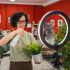 Mature woman have live stream on mobile phone about home plant care
