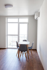 Modern dining area with a sleek table and chairs in a bright apartment setting