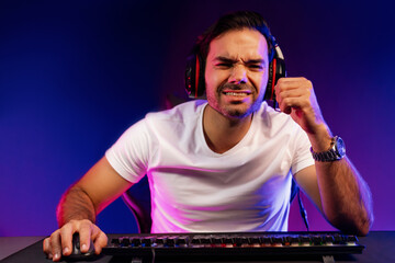 Serious face gaming streamer concentrating gaming players trying to pass at mission completed,...