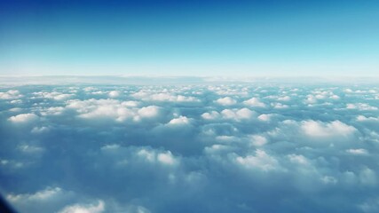 Pov from passenger commertical plane window on flight above fluffy clouds at sunrise, sunset - Powered by Adobe