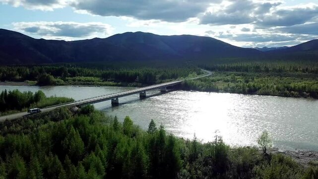 A helicopter view of the road and the bridge over the river.Traveling to Siberia and the Far East, Magadan region, Russia.