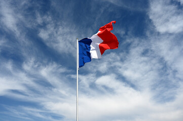 national flag of France fluttering in strong wind