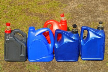 five red black and blue industrial new closed with lids empty discarded with oil plastic with...