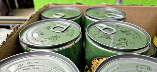 Green pull-tab food cans in box