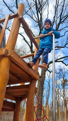 Young boy climbing wooden playground structure, building confidence and strength, active outdoor play, motor skill development for children