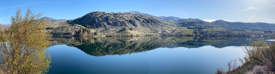 Wapato Lake in a sweeping panoramic view as seen from the Manson Scenic Loop drive with reflections on a beautiful early spring morning_20250405.4041.