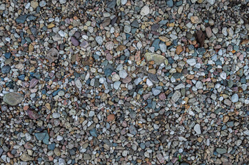 Sea pebble texture on footpath as background.