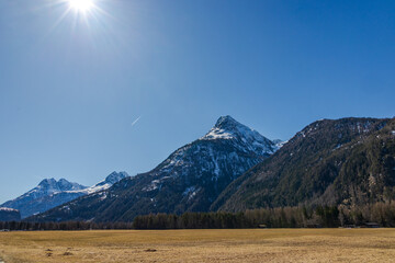 Sunny alpine landscape with snowy mountain and wide meadow, Ötztal, Austria, 20 March 2025..