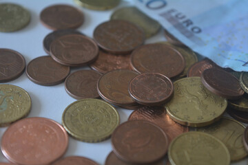 Pile of euro coins on euro notes.
