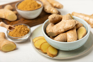 Fresh ginger on wooden background. Dry ginger. Sliced ​​ginger with honey and lemon. Ginger...