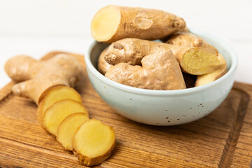 Fresh ginger on wooden background. Dry ginger. Sliced ​​ginger with honey and lemon. Ginger root. Traditional alternative medicine, healing tea for immunity. Seasoning and spices concept. Copy space.