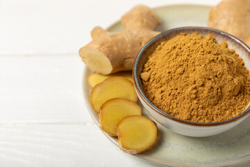 Fresh ginger on wooden background. Dry ginger. Sliced ​​ginger with honey and lemon. Ginger...