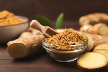 Fresh ginger on wooden background. Dry ginger. Sliced ​​ginger with honey and lemon. Ginger root. Traditional alternative medicine, healing tea for immunity. Seasoning and spices concept. Copy space.