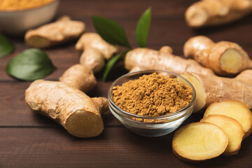 Fresh ginger on wooden background. Dry ginger. Sliced ​​ginger with honey and lemon. Ginger root. Traditional alternative medicine, healing tea for immunity. Seasoning and spices concept. Copy space.