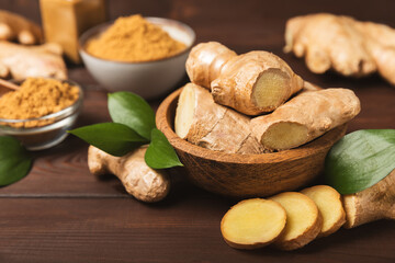 Fresh ginger on wooden background. Dry ginger. Sliced ​​ginger with honey and lemon. Ginger root. Traditional alternative medicine, healing tea for immunity. Seasoning and spices concept. Copy space.