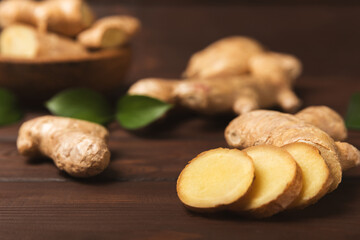 Fresh ginger on wooden background. Dry ginger. Sliced ​​ginger with honey and lemon. Ginger root. Traditional alternative medicine, healing tea for immunity. Seasoning and spices concept. Copy space.