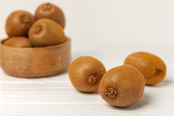 Kiwi on wooden background. Whole fruit and slices pieces of green kiwi on table. fresh ripe juicy kiwi. Tropical fruit. Organic fruit. Healthy eating. Space for text. Copy space