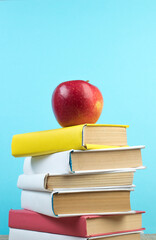 Books stacking. Books on wooden table and blue background. Back to school. Copy space for ad text.