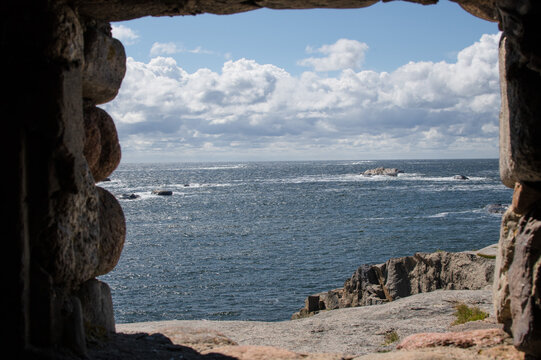 A view of the sea from the window of a historic stone lighthouse