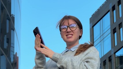 woman looking at phone and having trouble seeing, vision problem