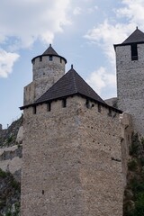 Obraz premium Medieval architecture. Protective fortification. Fortress on the river bank. Architectural elements of a medieval stone fortress.