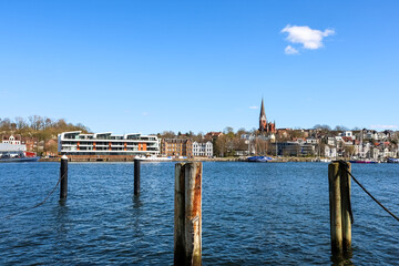 Flensburg, Germany - 05. April 2025: Flensburg cityscape reflecting on the Baltic sea in a sunny...