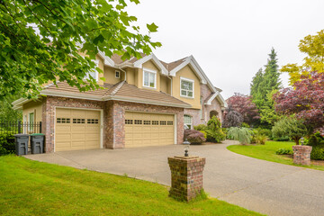 Garage door in luxury house with trees and nice landscape in Summer in Vancouver, Canada, North...