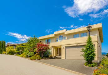 Fototapeta premium Garage door in luxury house with trees and nice landscape in Summer in Vancouver, Canada, North America. Day time on June 2024.