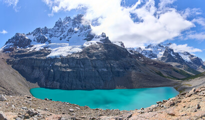 View point Mirador Cerro Castillo in national park in Chile. Cerro Castillo mountain and a lake with turquoise water. One of the best tourist destinations along Carretera Austral. Tourists in a trail.