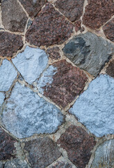 Rustic stone wall showing rough granite textures and solid construction