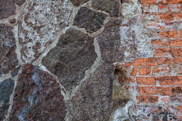 Rustic stone wall showing rough granite textures and solid construction