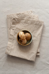 Сloth napkins in a warm colors on a beige cotton tablecloth. Minimalistic composition with natural...