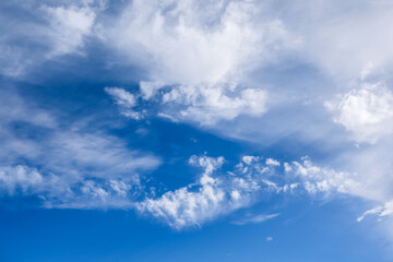 Fototapeta premium White Clouds Drifting Across a Vibrant Blue Sky