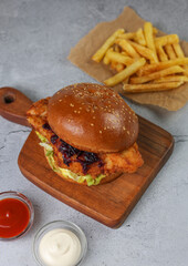Homemade delicious burger and ketchup, fries.