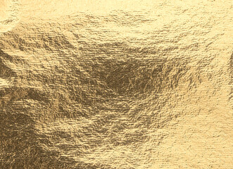 A vintage, golden foil background with a rich, metallic texture. The crumpled, reflective surface features a chic, grunge pattern, perfect for a holiday or Christmas card. Elegant, pearlescent finish.