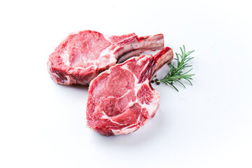 Raw dry aged bone-in back veal chops offered as close-up on white background