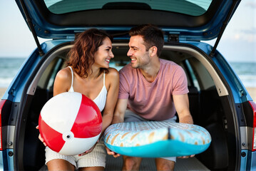 Happy Couple Enjoying a Beach Day with Car Trunk Open and Beach Gear