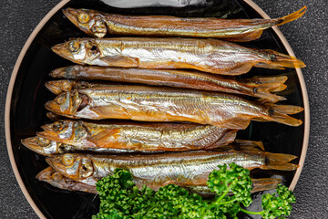 Smoked sprat fish capelin dish fresh gourmet food background on table rustic food top view copy...