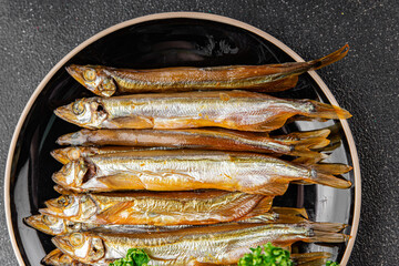 Smoked sprat fish capelin dish fresh gourmet food background on table rustic food top view copy...