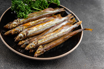 Smoked sprat fish capelin dish fresh gourmet food background on table rustic food top view copy...