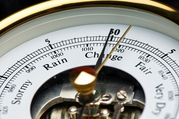 Close-up of old fashioned barometer pointing to Change